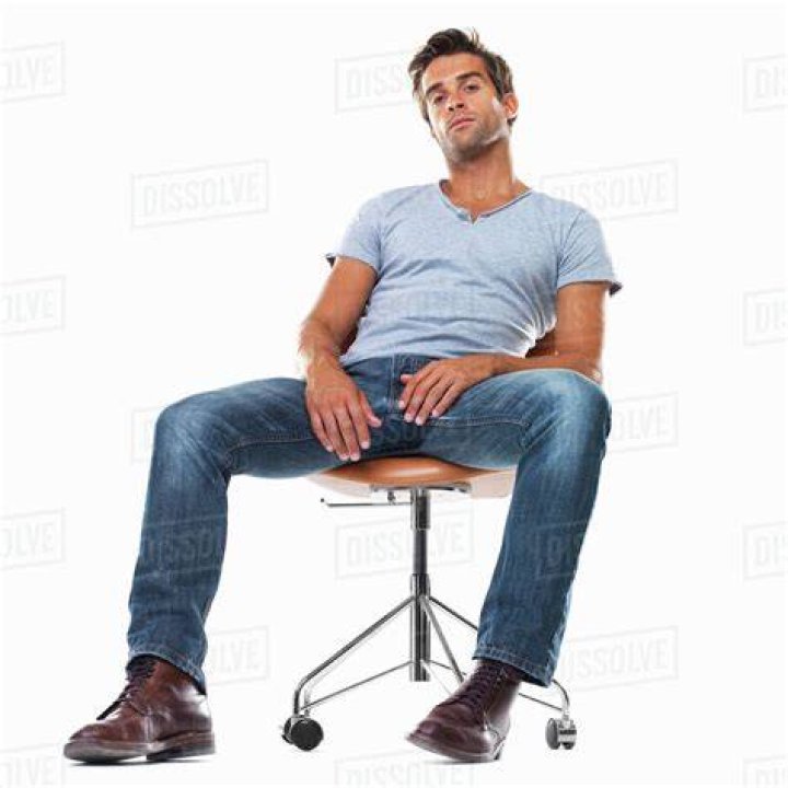 a man sitting at a desk in front of a tv with his head on the table